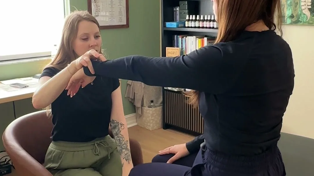 Dr. Leah muscle testing a patient during Neuro-Emotional Technique (NET) in Fort Myers