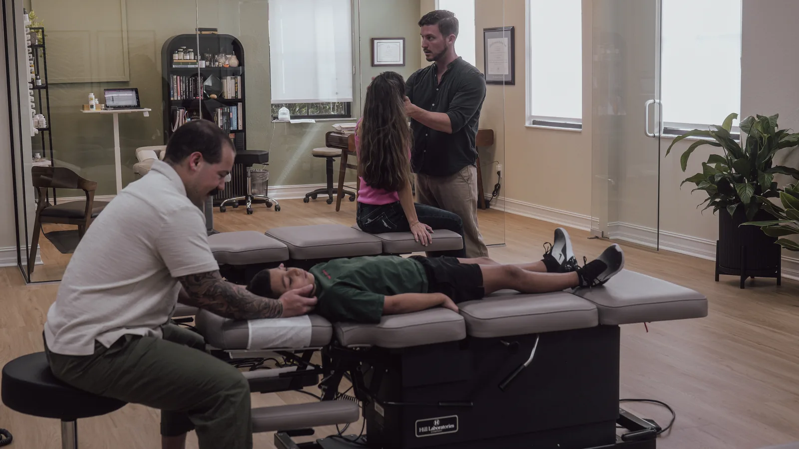 Fort Myers pediatric chiropractor Dr. Diego Torres gently adjusting a young boy