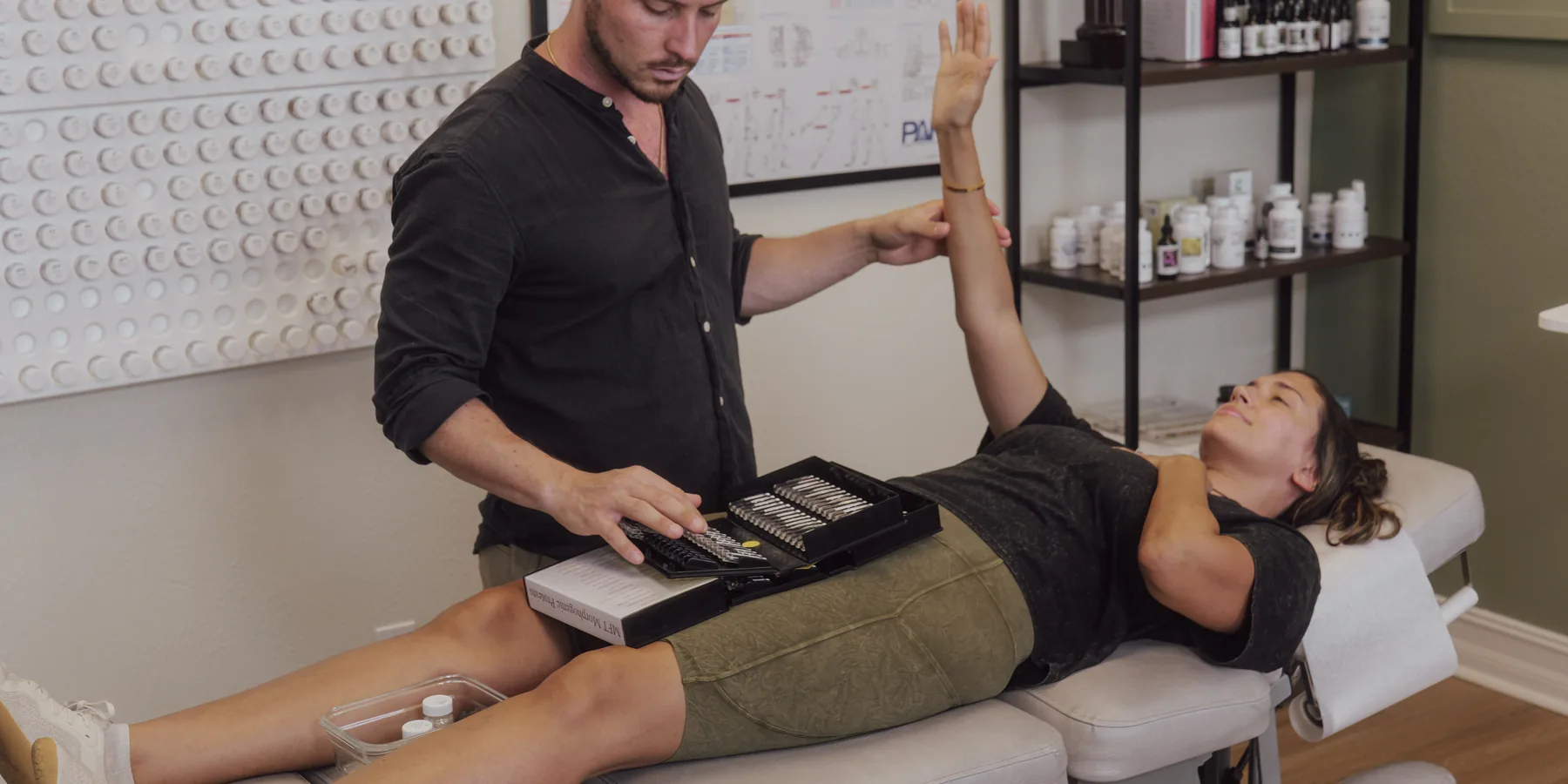 Dr. Jarod Ward performing Nutrition Response Testing on a patient at Crown Chiropractic in Fort Myers, FL