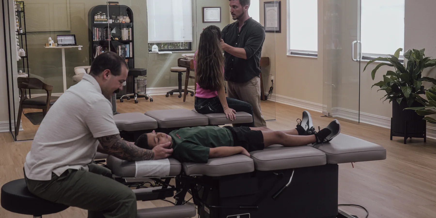Dr. Diego Torres gently adjusting a young boy's neck at Crown Chiropractic, a pediatric chiropractor in Fort Myers, FL