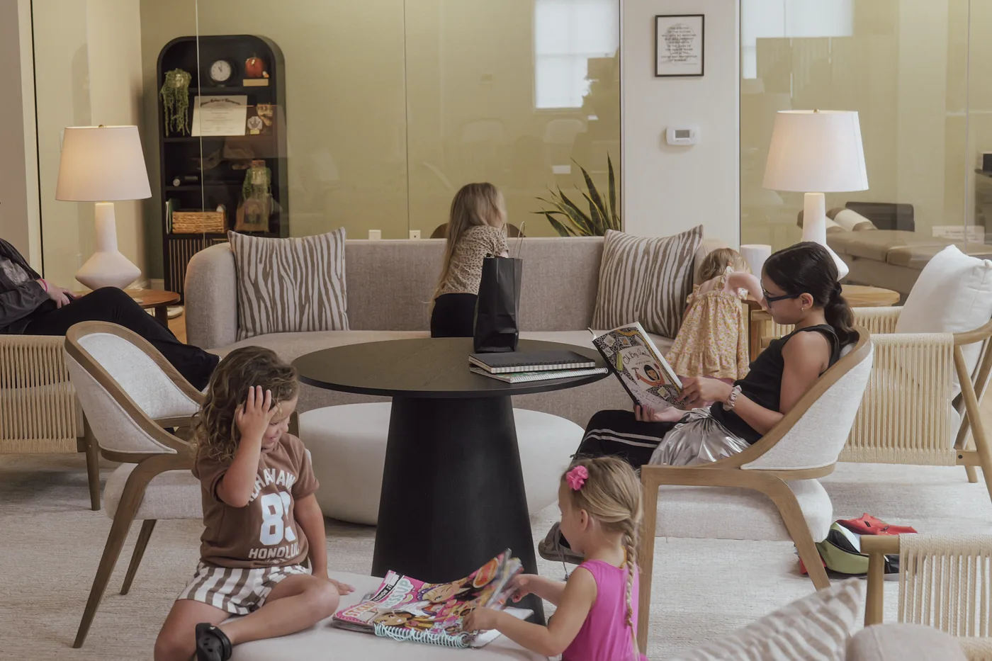 Children reading in the family lounge at Crown Chiropractic's Parker Commons office in Fort Myers