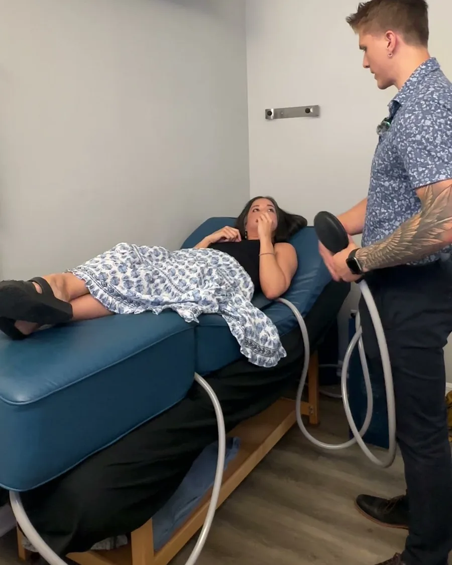Dr. Gabe Mash setting up PEMF therapy for a patient at Crown Chiropractic in Fort Myers, FL